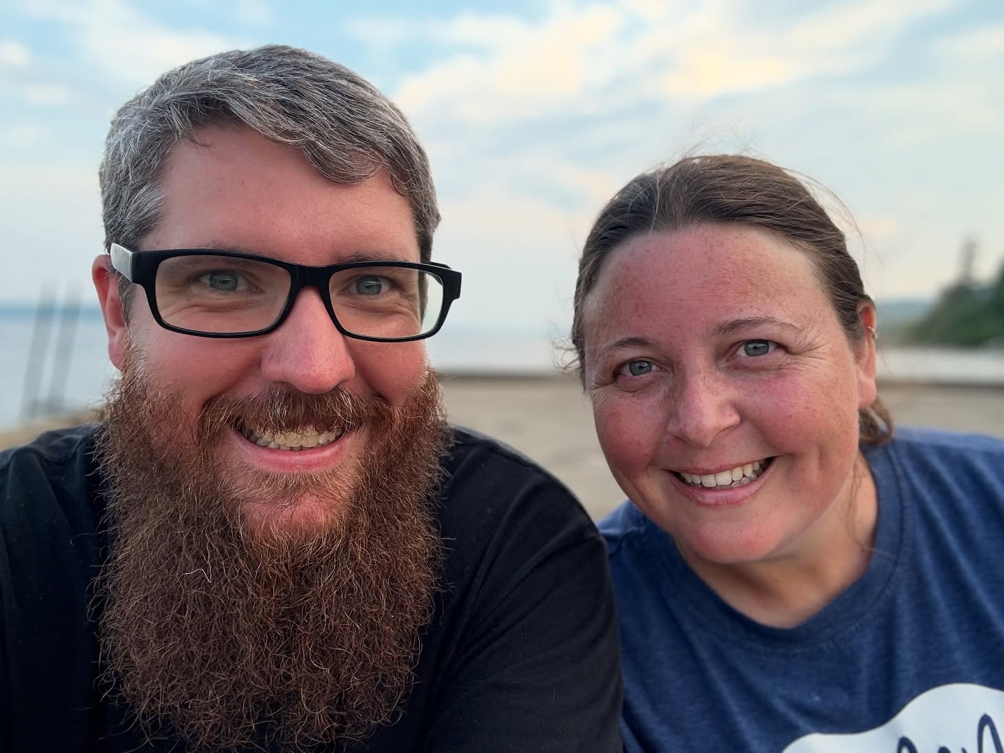 Stefan and Deborah smiling near the water.